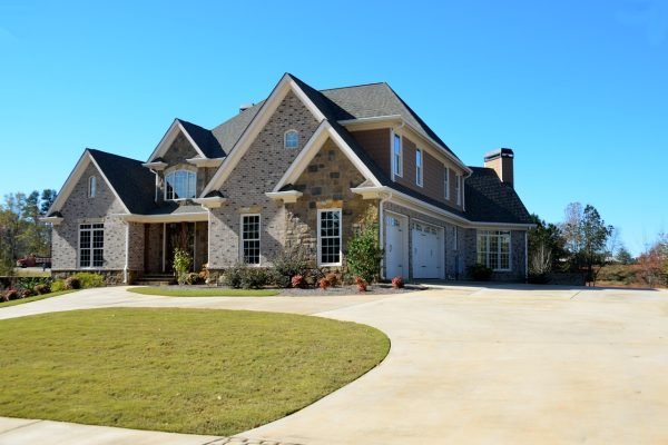 This is a real estate property with a driveway leading to a house.