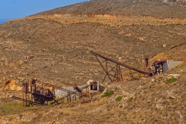 A rocky hillside with a mining site in the foreground.