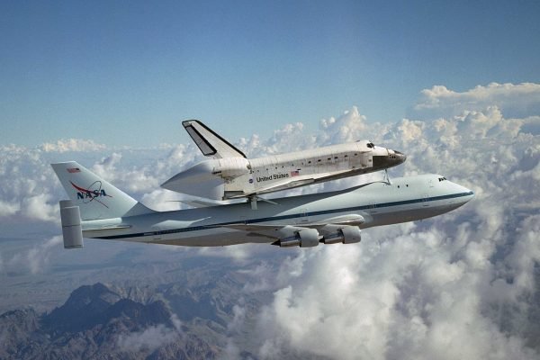 Nasa's space shuttle is being carried by a large 747 aircraft representing aerospace and defence.