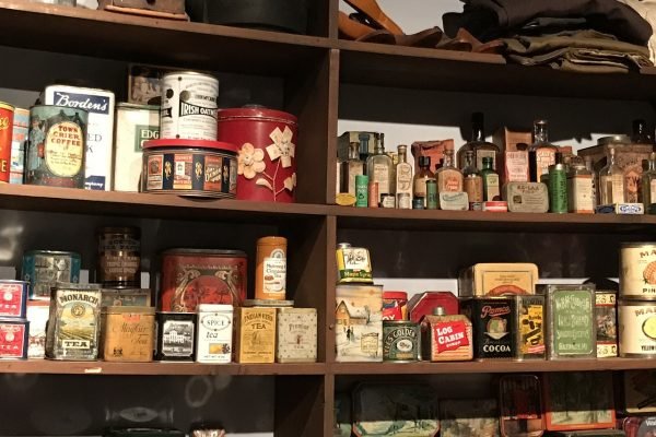 A display of old tin cans, showcasing consumer packaged goods from the past.